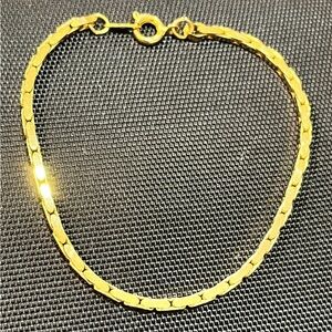 Gold tone bracelets.